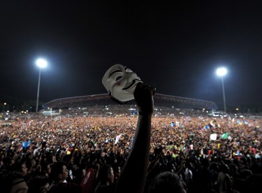 A protester holds up an "anonymous" mask during an opposition coalition rally. Photo by Hafzi Mohamed, Copyright @Demotix (5/8/2013)