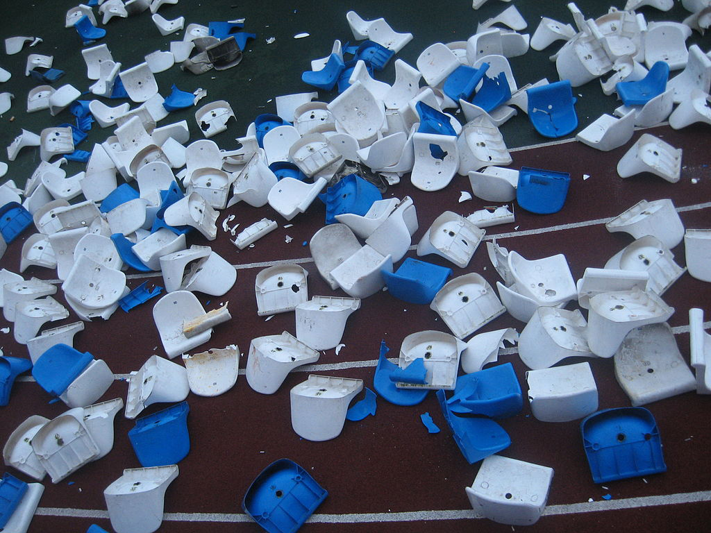 Broken plastic chairs in stadium, after a football game. Bryansk, Russia, 2008. Source: Wikimedia, Creative Commons 3.0 license.