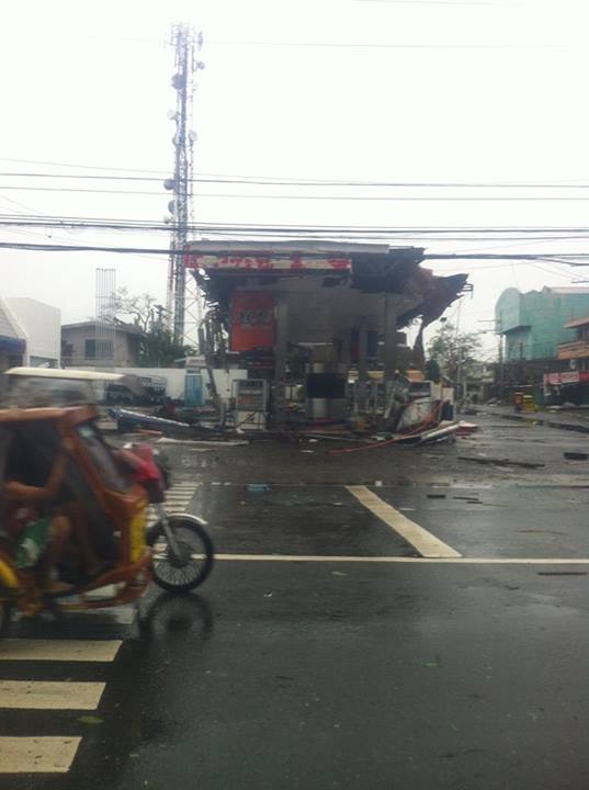 A tricycle passes by a ruined gas station in Roxas City. Photo by Kashmer Diestro, Facebook