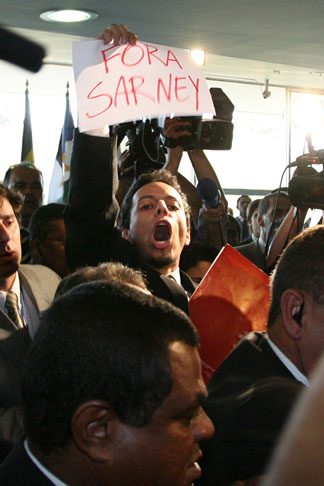 André Dutra is seing holding a "Get out Sarney!" flyer.