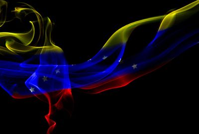 Photo of Venezuelan flag in smoke by ··· Mango Verde con Sal ··· and used under a Creative Commons license.
