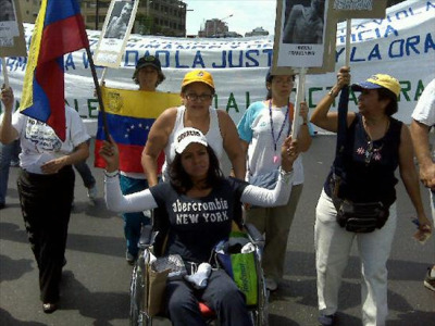 Photo of Elena Brito at demonstration courtesy of Brito and Habla Venezuela.