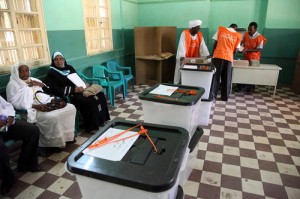 Staff with the National Elections Commission prepare ballots at a polling station in Khartoum, Sudan.