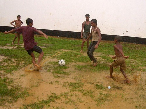 Playing soccer in the rain. Image By Flickr user Vipez. CC BY-NC-ND 