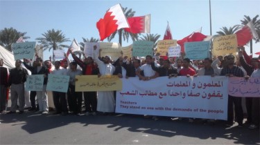 Largest banner: Teachers standing with the people's demands. Taken from the Bahrain Teachers Society website