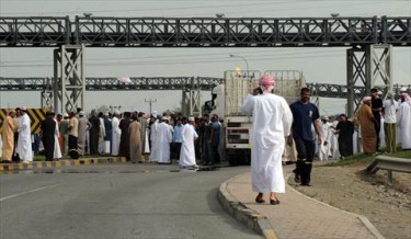 Pro reform protesters block the Sohar Port entrance 
