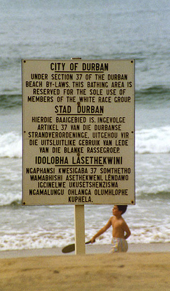 Apartheid era sign in Durban, South Africa. Photo released to Wikimedia Commons by user Guinnog