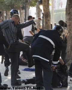 A Tunisian protestor beaten by a policeman in civilian clothes, May 6, 2011. Photo by Twitpic user @worldwideyes.