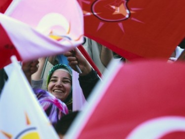 Supporters of Turkey's ruling AKP party celebrate with party flags after the first results of the parliamentary election, in Istanbul, Turkey. Image by keremyucel, copyright Demotix (12/06/11).