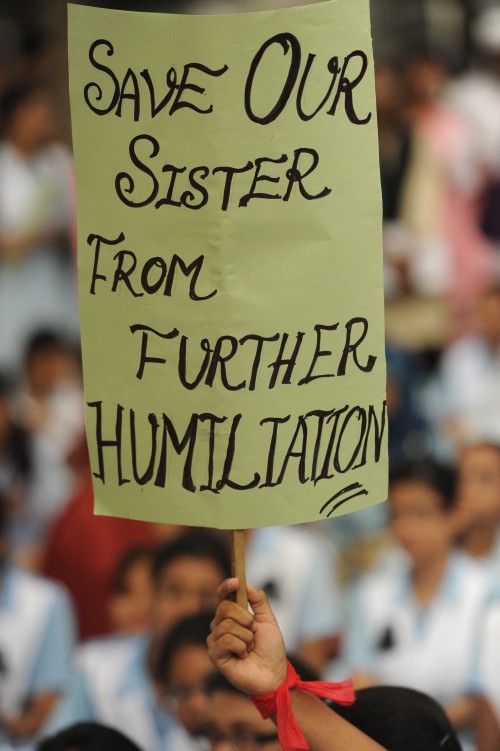 Students hold placards denouncing sexual abuse at their school, as they gather at the Central Shaheed Minar. Image by Safin Ahmed. Copyright Demotix.