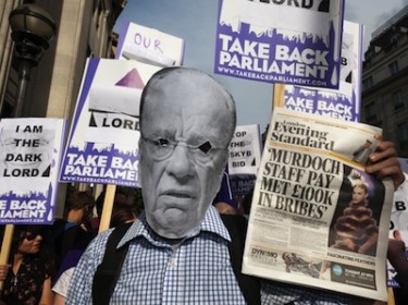 Protester with Murdoch mask, placards and newspaper headline outside the UK Department of Culture, Media and Sport. Image by Peter Marshall, copyright Demotix (07/07/2011).