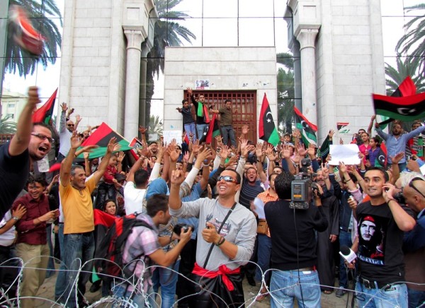 Tunisians and Libyans celebrate the demise of Gaddafi in front of the Libyan Embassy in Tunis with the Libyan flag. Image by Hamideddine Bouali. Copyright Demotix (20/10/2011)