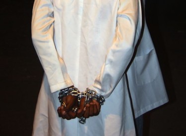 An activist dressed as a doctor demonstrates in support of those arrested for helping injured protestors in Bahrain.