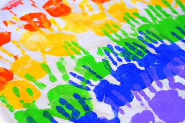 multicolor handprints on white cloth