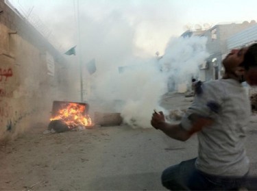A protester being hit by a rubber bullet at the time of impact