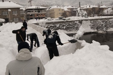 Men shoveling snow from a street in Sarajevo. Record snowfall has paralyzed transportation in the Bosnian capital, where a state of emergency has now been declared. Photo by Sulejman Omerbasic, copyright © Demotix (5/02/12).