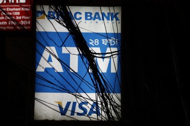 Phone wires entangled around a ATM signboard in Dhaka. Image from Flickr by Joe Athialy. CC BY-NC 2.0