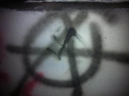 Nazi swastika graffiti over D.I.Y. anarchy symbol, from gayarmenia.blogspot.com