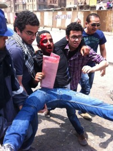 Wounded and bloodied being carried away from Abbassiya. Image by Twitter user @sharifkouddous.