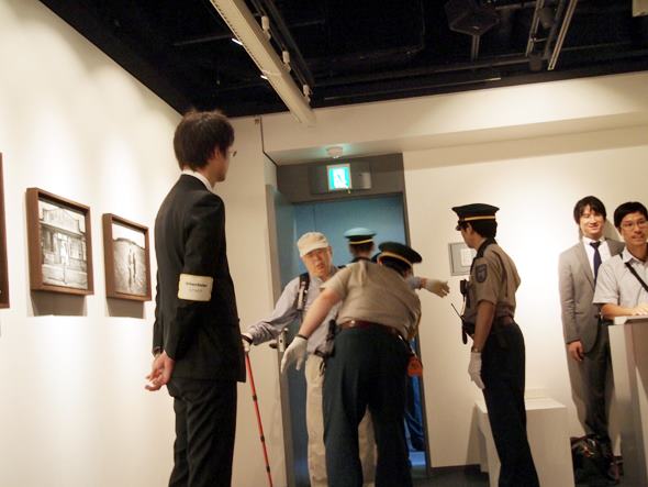 Visitor Being Patted Down Upon Entering the Photo Exhibit