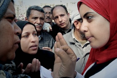 Film Still from Words of Witness, showing Heba listening to testimonials on Tahrir Square, Cairo