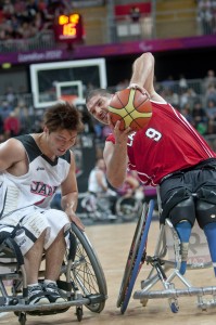 Adam Lancia is blocked by Shingo Gujii during the preliminary group B wheelchair basketball match between Canada and Japan. Image by Clive Chilvers, copyright Demotix (30/08/12).
