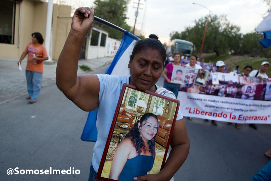 Suyapa Socorro walks through the streets of Reynosa, Mexico, holding an image of her missing daughter. Photo by Mario Marlo