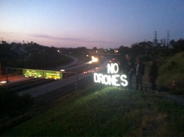 No Drones sign in neon overlooking a highway in San Diego (shared via twitter by Rooj Alwazir)