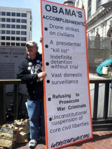 A protestor in the anti-drones protest in San Farancisco holding a sign opposing drones and extrajudicial killings