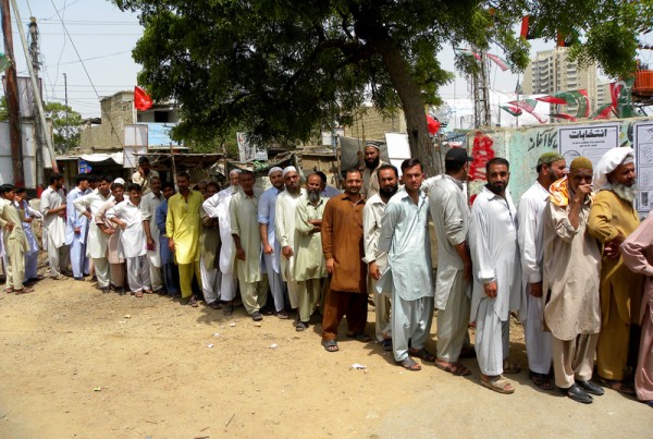 People stand in a queue to cast their vote at a polling station during the phase of the election in Karachi, Pakistan on Saturday 11 may 2013.  Hundreds of thousands of Pakistanis went to the polling stations. Image by Rana Zahid 84. Copyright Demotix (11/5/2013)