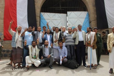Yemen's Revolution's Youth and supporting activists pose in front of Sanaa's central prison after their release