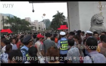 Anxious parents wait outside the exam site in China's eastern Fujian province( Screen grab from Youku .)