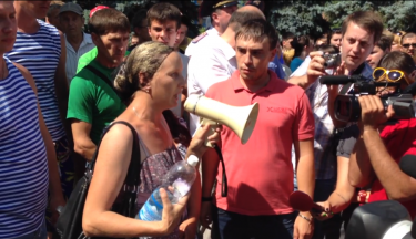 Marzhanov's mother addressing the crowd and speaking about her son's military service. YouTube screenshot.