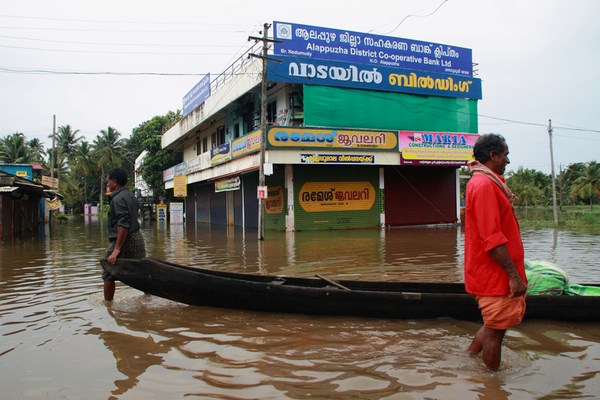 Kuttanad, India. 26th June 2013 -- A boat as pictured here is floating on the road submerged in flood water.