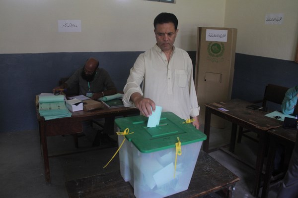 A man is casting his vote in Islamabad during by-elections. Image by Shiraz Hassan. Copyright Demotix (22/8/2013)