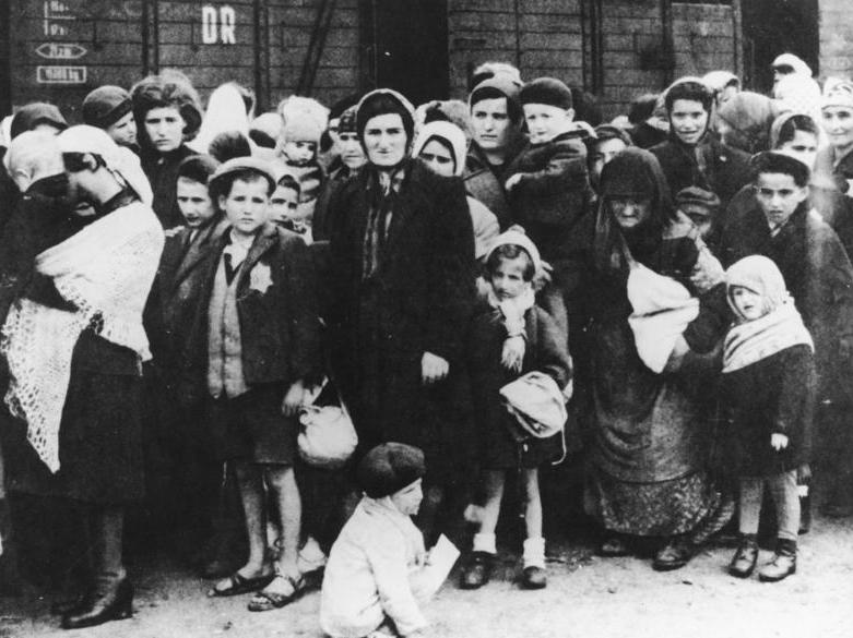 A group of Jewish men, women and children being led to a concentration camp during WW II; photo provided by by the German Federal Archives, used under Creative Commons 3.0 license.  