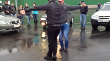 Two men dancing the lezginka on a Barnaul street. YouTube screenshot.