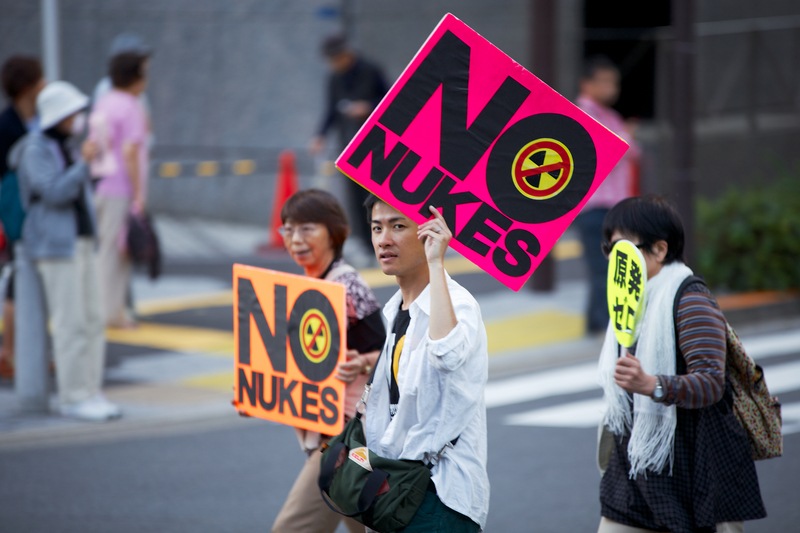 Protesters hold signs against nuclear power on the streets of Tokyo. The population's concerns over nuclear power in Japan have increased after the radioactive spill in Fukushima.<br /> Photo by KAZUMAC, copyright (c) Demotix (October 13, 2013)