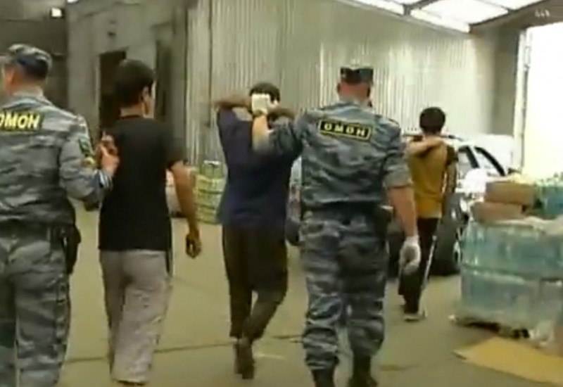 Migrants detained at a raid on a Moscow market. Authorities have been cracking down in what some see as an appeal to Russian nationalism. YouTube screenshot.