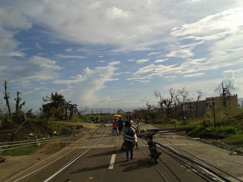 Typhoon survivors walk the streets of Ormoc, Leyte. Notice the fallen electric posts and trees. Photo from Facebook of Katreena Bisnar 