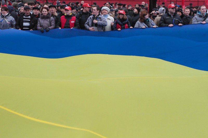 Protesters gathered under flags in Kyiv to demand the Ukrainian government to reverse its policy decision and sign a landmark agreement with the EU; photo by Sergii Kharchenko, courtesy of Demotix, used with permission. 