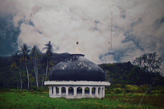 The top of a mosque moved more than a mile by the 2004 Indian Ocean tsunami, as depicted in a poster displayed at the Aceh Tsunami Museum, Banda Aceh, Indonesia. Photo by Ivan Sigal, 2012.