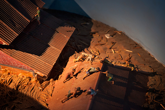 Diorama depicting people clinging to roofs, Aceh Tsunami Museum, Banda Aceh, Indonesia. Photo by Ivan Sigal, 2012.