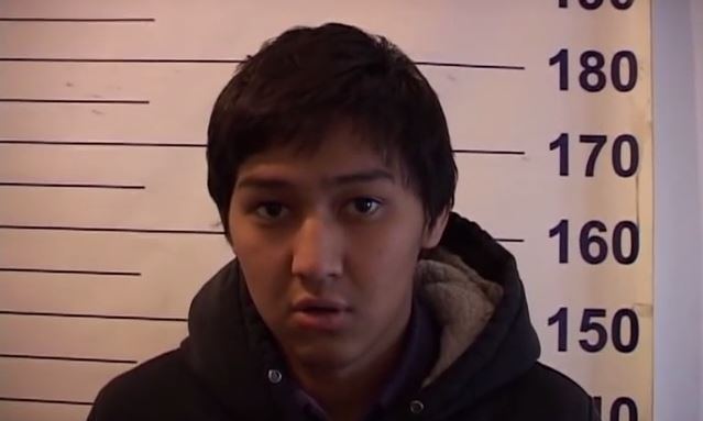 Timur Tashiev in police custody. Screen capture from YouTube video uploaded by Kiyalbek Toichiev on December 2, 2013.