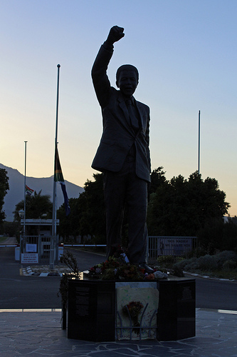 Mandela statue outside Drakenstein prison, in silhouette; photo by HelenSTB