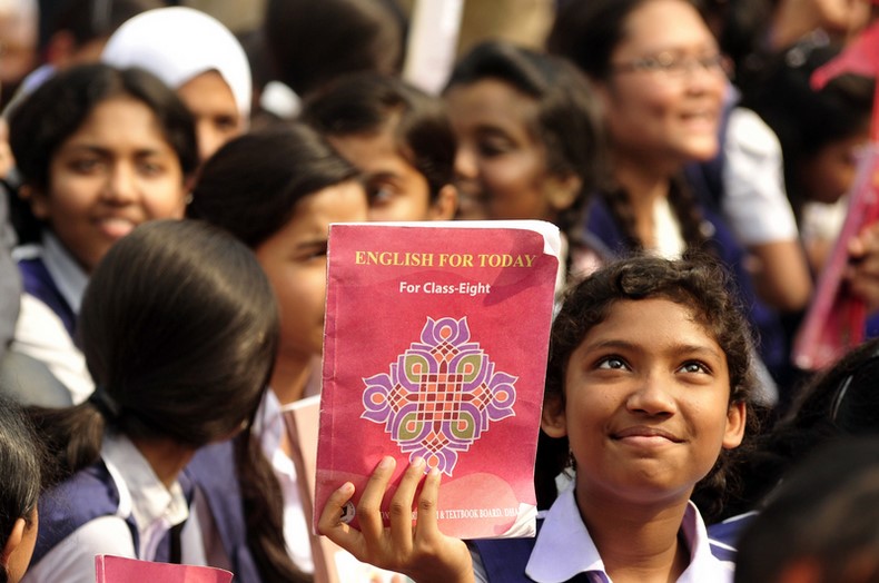 A Student rises up a textbook during the "Textbook Festival Day" program organized by Education Ministry at capital's Government Laboratory School. Image by Firoz Ahmed. Copyright Demotix (2/1/2014)