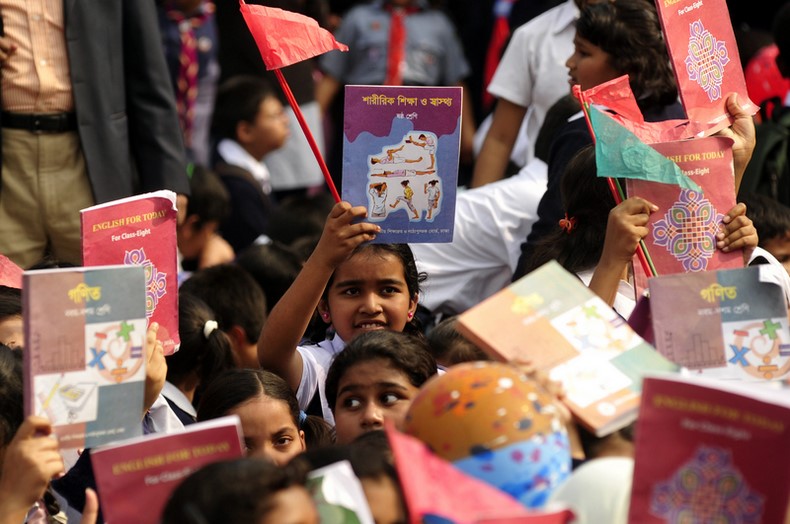 Students rise up textbooks during the "Textbook Festival Day" program organized by Education Ministry at capital's Government Laboratory School. Image by Firoz Ahmed. Copyright Demotix (2/1/2014)