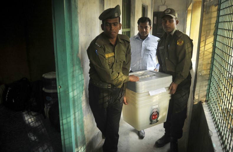 Guards carry ballot boxes and equipment to a polling station that will be used for the 10th parliamentary elections. Image by Naveed Ishtyak. Copyright Demotix (4/1/2014)