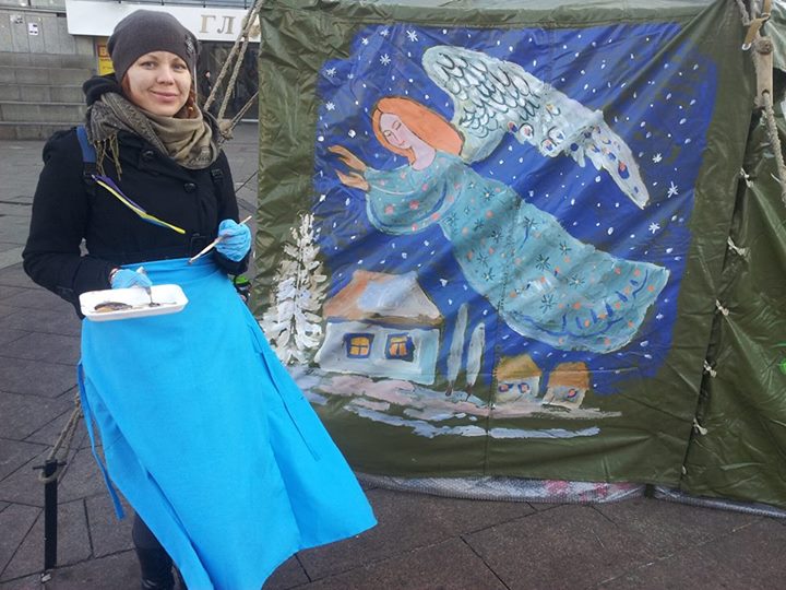 A woman painting a tent at the main protest grounds in Kyiv. Photo by a creator of Facebook page 'Maidaners'. Used with permission.