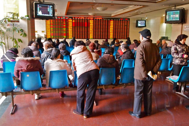 People in the trading hall of a stock and securities exchange company in downtown Shanghai China. Photo by Remko Tanis CC: AT-SA-NC
